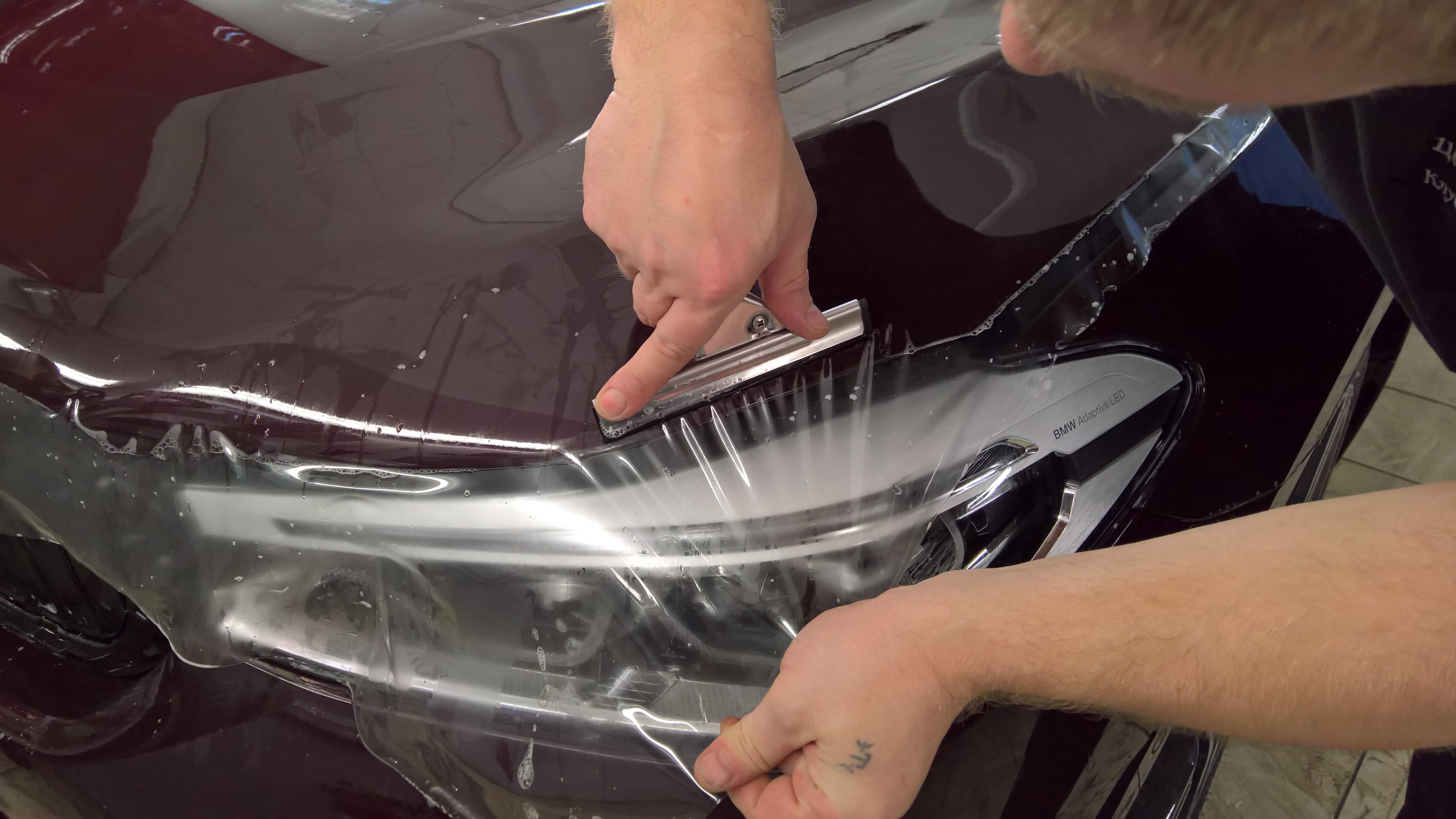 Paint protection film application on a vehicle bumper